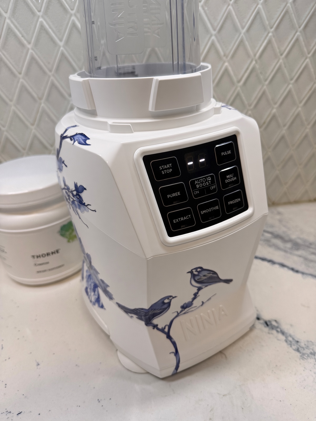 White Ninja blender with blue birds on the front